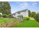 Manicured backyard features a well-kept lawn, mature trees, and charming landscaping at 7108 Hummingbird Ln, Winston, GA 30187