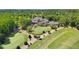 Beautiful aerial view of the golf course and clubhouse surrounded by lush greenery at 8430 Merion Drive, Duluth, GA 30097