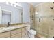Bathroom with stone shower and granite countertops on vanity at 8430 Merion Drive, Duluth, GA 30097