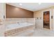 Luxury bathroom features a soaking tub and sauna with glass door at 8430 Merion Drive, Duluth, GA 30097