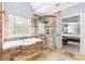 Luxurious bathroom boasts a soaking tub, a glass-enclosed shower, and seamless access to the adjacent bedroom at 8430 Merion Drive, Duluth, GA 30097
