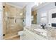 Bathroom with stone shower and granite countertops on vanity at 8430 Merion Drive, Duluth, GA 30097