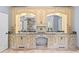 Elegant bathroom vanity showcases custom cabinetry, dual sinks with marble countertops, and stylish mirrors and lighting at 8430 Merion Drive, Duluth, GA 30097