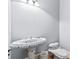 Unique bathroom sink and toilet with a beautiful blue pattern at 8430 Merion Drive, Duluth, GA 30097