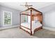 Bedroom featuring four-poster bed frame and natural lighting at 8430 Merion Drive, Duluth, GA 30097