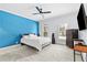Modern bedroom with an accent wall, ceiling fan, and natural light streaming through the plantation shutters at 8430 Merion Drive, Duluth, GA 30097