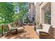 Inviting outdoor deck features comfortable seating, grill, and a peaceful view of the surrounding trees at 8430 Merion Drive, Duluth, GA 30097