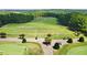 Aerial view of a community driving range with lush greens and mature trees in the background at 8430 Merion Drive, Duluth, GA 30097
