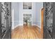 Elegant foyer with hardwood floors, high ceilings, and wrought iron staircase leading to the second level at 8430 Merion Drive, Duluth, GA 30097