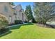 Manicured front lawn leads to an impressive brick facade and arched entryway of a beautiful house at 8430 Merion Drive, Duluth, GA 30097