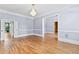 Spacious living room with chandelier and doorway at 8430 Merion Drive, Duluth, GA 30097