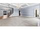Spacious living room with coffered ceilings, a staircase, and access to the foyer and outdoor patio at 8430 Merion Drive, Duluth, GA 30097