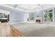 Open-concept living room with fireplace and large windows at 8430 Merion Drive, Duluth, GA 30097