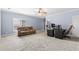 Expansive living room offering versatile space, a comfortable couch, and dedicated desk areas with modern computer setups at 8430 Merion Drive, Duluth, GA 30097