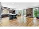 Spacious open concept living area with kitchen island, stone fireplace, and hardwood flooring at 8430 Merion Drive, Duluth, GA 30097
