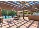 Outdoor kitchen and patio with a built-in grill and ample seating, great for entertaining and dining al fresco at 8430 Merion Drive, Duluth, GA 30097
