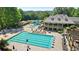 Stunning community pool area with a slide, sun loungers, and building with outdoor balconies at 8430 Merion Drive, Duluth, GA 30097
