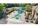 Aerial view of the community water park, featuring slides, splash pad, and seating areas for Gathering fun at 8430 Merion Drive, Duluth, GA 30097