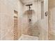 Beautiful tiled shower with rain shower head and mosaic accents at 8430 Merion Drive, Duluth, GA 30097