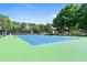 Well-maintained community tennis court with a covered seating area and lush greenery at 8430 Merion Drive, Duluth, GA 30097