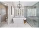 Elegant bathroom featuring a freestanding tub, large glass shower, and modern chandelier at 1006 Kingsbridge Vw, Powder Springs, GA 30127