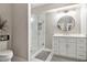 Modern bathroom with glass shower, white vanity, and decorative mirror at 1006 Kingsbridge Vw, Powder Springs, GA 30127