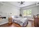 Comfortable bedroom with hardwood floors, ceiling fan, and natural light from a large window at 1006 Kingsbridge Vw, Powder Springs, GA 30127