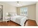 Comfortable bedroom with neutral tones, hardwood floors, and bright window at 1006 Kingsbridge Vw, Powder Springs, GA 30127