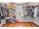 Large walk-in closet with custom shelving and hardwood floors at 1006 Kingsbridge Vw, Powder Springs, GA 30127