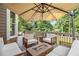 Relax on this backyard deck with comfortable seating and a cozy fire pit table at 1006 Kingsbridge Vw, Powder Springs, GA 30127