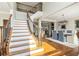 Bright foyer with hardwood floors, elegant staircase, and open access to dining area at 1006 Kingsbridge Vw, Powder Springs, GA 30127