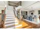 Inviting foyer featuring a staircase with wood and iron railing adjacent to a dining area at 1006 Kingsbridge Vw, Powder Springs, GA 30127