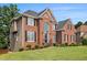 Stately brick home with well-manicured lawn and classic architectural details at 1006 Kingsbridge Vw, Powder Springs, GA 30127