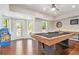 Entertaining game room with a pool table, arcade games and outdoor access at 1006 Kingsbridge Vw, Powder Springs, GA 30127