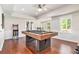Spacious game room with a pool table, arcade games, and natural light at 1006 Kingsbridge Vw, Powder Springs, GA 30127