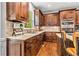 Charming kitchen with wood cabinets, granite counters, tile backsplash and modern appliances at 1006 Kingsbridge Vw, Powder Springs, GA 30127