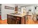 Close up of island with gas stove and granite countertop with chairs at 1006 Kingsbridge Vw, Powder Springs, GA 30127