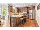 Modern kitchen featuring an island with bar seating, stainless steel appliances, and ample cabinetry at 1006 Kingsbridge Vw, Powder Springs, GA 30127