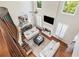 Bright, open living room with fireplace, hardwood floors, and tall windows at 1006 Kingsbridge Vw, Powder Springs, GA 30127