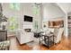 Spacious living room with fireplace, soaring ceilings, large windows, and wood floors at 1006 Kingsbridge Vw, Powder Springs, GA 30127