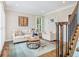Cozy living room with comfortable seating, stylish decor, and staircase at 1006 Kingsbridge Vw, Powder Springs, GA 30127