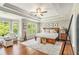 Spacious main bedroom with tray ceiling, hardwood floors, and many windows at 1006 Kingsbridge Vw, Powder Springs, GA 30127