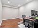 Home office with hardwood floors, neutral paint, and a desk with dual monitors for a productive workspace at 1006 Kingsbridge Vw, Powder Springs, GA 30127