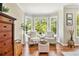 Cozy sitting area with hardwood floors and bay windows offering tree views at 1006 Kingsbridge Vw, Powder Springs, GA 30127
