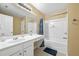 This bathroom features a tub shower, ample vanity and countertop space, and a neutral color palette at 1414 Dolcetto Nw Trce # 14, Kennesaw, GA 30152