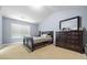 This inviting bedroom features a serene atmosphere with neutral tones, natural light, and a dark wood dresser at 1414 Dolcetto Nw Trce # 14, Kennesaw, GA 30152