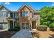 Charming two-story townhouse with brick facade, attached garage, and well-maintained landscaping at 1414 Dolcetto Nw Trce # 14, Kennesaw, GA 30152