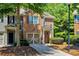 Two-story townhouse featuring a brick facade, attached garage, and neatly landscaped front yard at 1414 Dolcetto Nw Trce # 14, Kennesaw, GA 30152