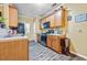 Functional kitchen featuring wood cabinets, black appliances, and durable wood-look flooring at 1414 Dolcetto Nw Trce # 14, Kennesaw, GA 30152