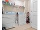 Well-lit laundry room with a washer, dryer, shelving, and neutral flooring at 1414 Dolcetto Nw Trce # 14, Kennesaw, GA 30152